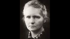 an old black and white photo of a woman with curly hair wearing a bow tie