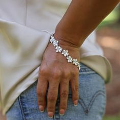 The Plumeria Bracelet in Sterling Silver features the Hawaiian flower of welcome, the Plumeria. The gorgeous satin-finished plumerias in various sizes create a beautiful bouquet of flowers you will love displaying on your wrist. Plumeria Design Bracelet Sterling Silver 13mm Approximately 7.75" - 8" in Length Exclusively Made in Hawaiʻi Forever Guarantee (Warranty on the life of the piece) Free Shipping on USA Orders $100 or more Plumeria Bracelet, Plumeria Design, Hawaiian Flower, Bracelets Design, Design Bracelet, Unique Fragrance, Beautiful Bouquet Of Flowers, Hawaiian Flowers, Bouquet Of Flowers