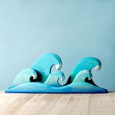 two blue surfboards sitting on top of a wooden table