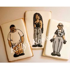 three decorated cookies with images of baseball players on them, one is white and the other is black