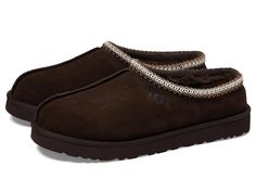 UGG Tasman - Men's Slippers : Dusted Cocoa : Casual, yet rugged, classic slipper. The Tasman always fits tight at first especially if someone has a high instep or high volume foot. It does stretch out over time. If you are in between sizes, please size up or down based on the volume of your foot and height of your instep. The UGG Tasman is a casual, yet rugged, classic slipper. Sheepskin laminated to cow suede adds durability to uncompromised comfort. Sheepskin laminated to cow suede adds durability to uncompromised comfort. Woven braid for retro fashion appeal. Light and flexible EVA outsole. 17mm UGGpure wool insole. 100% Premium wool fleece. Genuine fleece sock liner for comfort and warmth. Treadlite by UGG outsole provides increased traction, durability, cushioning and flexibility. Eas Grey Uggs, Ugg Slides, Ugg Tasman Slippers, Fleece Socks, Classic Slippers, Ugg Tasman, Men's Slippers, Suede Slippers, Braids With Weave