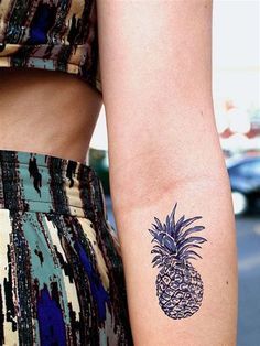 an image of a pineapple tattoo on someone's left arm and right arm