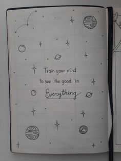 an open notebook with writing on it and space related images in the pages, along with a handwritten quote