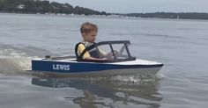 a young boy in a small boat on the water