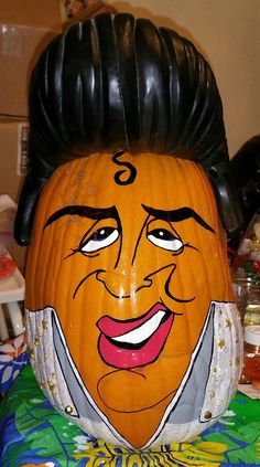 a carved pumpkin with a man's face on it and hair in the shape of a head