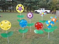 several different colored flowers are in the grass