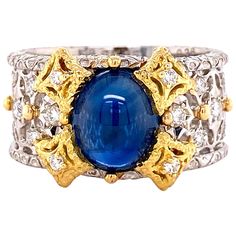 Simply Beautiful Platinum and 18K yellow Gold Cocktail Filigree Band Ring, securely set with a cabochon Sapphire, weighing approx. 2.65 Carat and accented by brilliant-cut Diamonds, approx. 0.36tcw. Hand crafted in Platinum and 18 Karat yellow Gold sections set symmetrically on the top section. Stamped: Pt 900, K18 & s2.65. Ring measuring approx. 0.81”w x 0.48”h x 0.90”d. Ring size 6, we offer ring resizing. Chic and Classic…Sure to be admired...Illuminating your look with Timeless Beauty! Navy Gold Wedding, Fancy Diamond Ring, Diamond Bracelet Design, White Gold Diamond Earrings, Diamond Watches For Men, Platinum Diamond Rings, Gold Cocktail Ring, Pendant Watches, Gold Cocktail