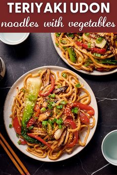 two plates filled with noodles and vegetables next to chopsticks on a table top