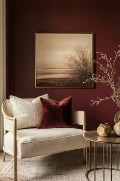 a living room with red walls and white furniture in the corner, along with a painting on the wall