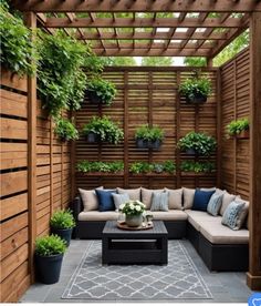 an outdoor living area with couches, tables and potted plants on the wall