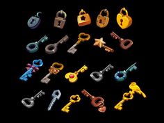 an assortment of keys on a black background