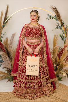 Rabiha - Velvet Bridal Lehenga choli w/ heavy Dabka, Cutdana & Zerkon work Let this burgundy quintessential bridal set do the talk of sheer joy & fantasy, designed just to be perfect for your big day! The Doli Barat patterning over the set is a resemblance of the rich Indian wedding culture and tells a story you will remember throughout your life. Boat neckline heavy embroidered bridal choli blouse Princess-cut patterning for perfect fitting Rich textured velvet fabric choli Modern yet Classic B Red Velvet Lehenga, Bridal Choli, Velvet Bridal Lehenga, Velvet Lehenga Choli, Embroidery Indian, Velvet Lehenga, Choli Blouse, Indian Wedding Wear, Wear Store