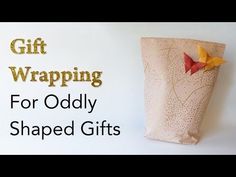 an origami gift wrapped in brown paper with the words, gift wrapping for oddy shaped gifts