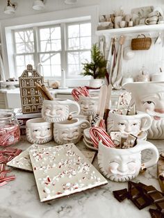 the kitchen counter is covered with candy canes, mugs and other decorative items