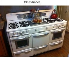 a white stove top oven sitting inside of a kitchen