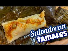 some food is sitting on top of foil wrapped in plastic wrappers and the words sauvadoran tamales above it