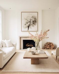 a living room filled with furniture and a fire place in front of a painting on the wall