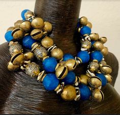 This bold, chunky and dramatic triple strand beaded necklace is heavy, so please know your tolerance before you purchase. If you are a serious buyer, I would be open to removing one of the strands to make this lighter. The components include beautiful blue African recycled glass beads, zebu bone rondelles, ornate vintage metal beads, Asian brass chimes, brass rings, faceted blue crystals and shiny gold balls. Adjusts from 18-22" with gold tone hardware, an xl fancy lobster claw clasp and a 4" ex Brass Rings, Recycled Glass Bead, Vintage Beads, Recycled Glass, Blue Crystals, Metal Beads, Multi Strand, Gold Beads, Beautiful Blue