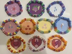 six paper plates are arranged in the shape of hearts and arrows, with beaded designs on them