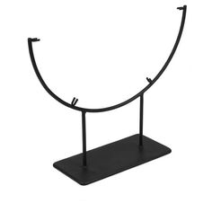 a black metal stand with two hooks on each end and an oval shaped object in the middle