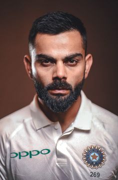 a man with a beard wearing a white shirt