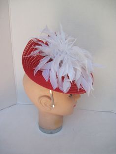 "* Red and White always looks so fresh and clean and this one is designed with lots of white spiky feathers that catch the breeze giving a feminine flair to the fascinator. * The hat form is about 12\" folded in back and tilted in a sophisticated design. * It is light weight, balanced and comfortable to wear year round. * Designed on a metal headband, it fits just about any head size and when viewed from any direction it looks complete, striking and eye catching. * Wear it throughout the year fo Red Feathered Fascinator Hat, Red Feathered Hat Fascinator, Red Feathered Summer Headpiece, Red Feathered Costume Hats And Headpieces For Summer, White Feathered Fascinator Hat, White Feathered Hat Fascinator, White Feathered Hat Headpiece, White Ostrich Feather Hat For Kentucky Derby, Vintage White Fascinator For Summer