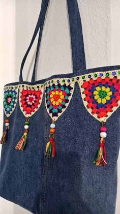 two bags with tassels hanging from the handles