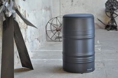 a large metal barrel sitting on top of a cement floor