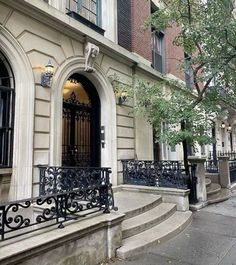 the entrance to an apartment building with wrought iron railings