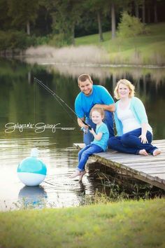 a man, woman and child fishing on a dock