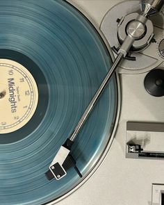 an old record player with its turntable and clock on the side, in front of it