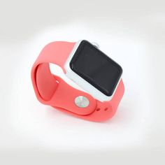 an apple watch sitting on top of a pink band with a white back and black face