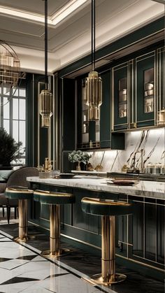 an elegant kitchen with green cabinets and marble counter tops, gold trimming on the island