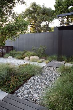 an outdoor garden with rocks and grass