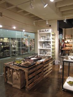 the interior of a store with glass walls and shelves filled with various types of items