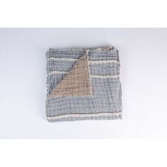 a piece of cloth that has been folded on top of it, with a tan and blue stripe