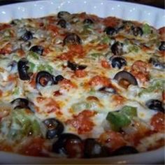 a pizza with black olives, tomatoes and cheese