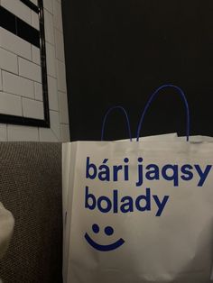 a white bag with the words bar jaquesy bolady written on it