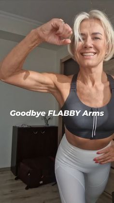 an older woman flexing her muscles in the living room