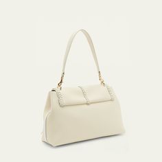 Chloe "Penelope" calf leather shoulder bag with whipstitch and tassel trim  Detachable flat top handle Detachable shoulder strap Flap top with flip-lock closure Interior, zip pocket Lining: linen Approx. 9.4"H x 13.8"W x 5.1"D Professional cleaning recommended Made in Italy