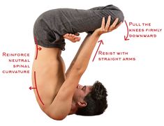 a man is doing an upside down yoga pose