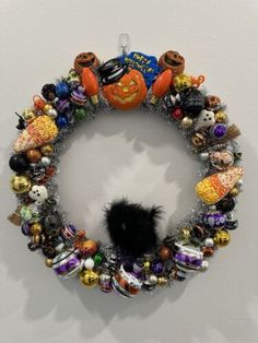 a wreath made out of halloween decorations on a wall