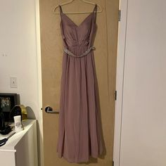 a dress hanging on a door in a room