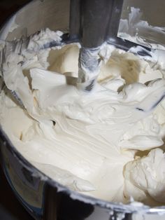 a mixing bowl filled with white batter on top of a counter