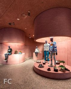 two mannequins are standing in the middle of a room with pink walls