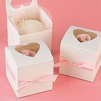 two white boxes with pink bows and hearts on the top, one has a baby's head in it