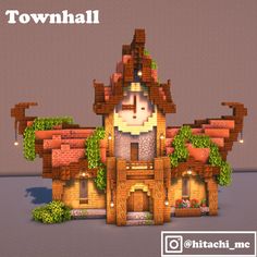 a house made out of bricks with plants growing on it and the words town hall above it