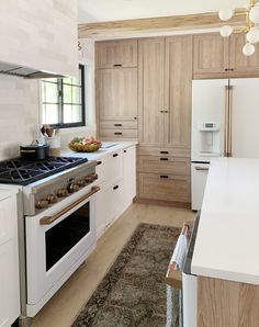 a kitchen with an oven, stove and cabinets in it's center island area