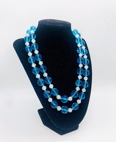 Beautiful vintage chunky double strand faceted blue glass beaded necklace. Large aqua blue faceted beads separated by white opaque glass beads. Has hook and dangle clasp. Shortest strand (closest to the neck) measures 22 inches long and the long strand is 24 inches long. The large blue beads are 1/2 inch across. Excellent vintage condition with minimal wear. No chips or cracks. Stringing secure. Beautiful color !! Glass Bead Necklace, Necklace Vintage, Blue Beads, Faceted Bead, Beaded Necklaces, Blue Glass, Vintage Necklace, Aqua Blue, Necklace Etsy