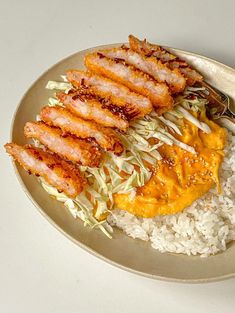 a white plate topped with rice and meat